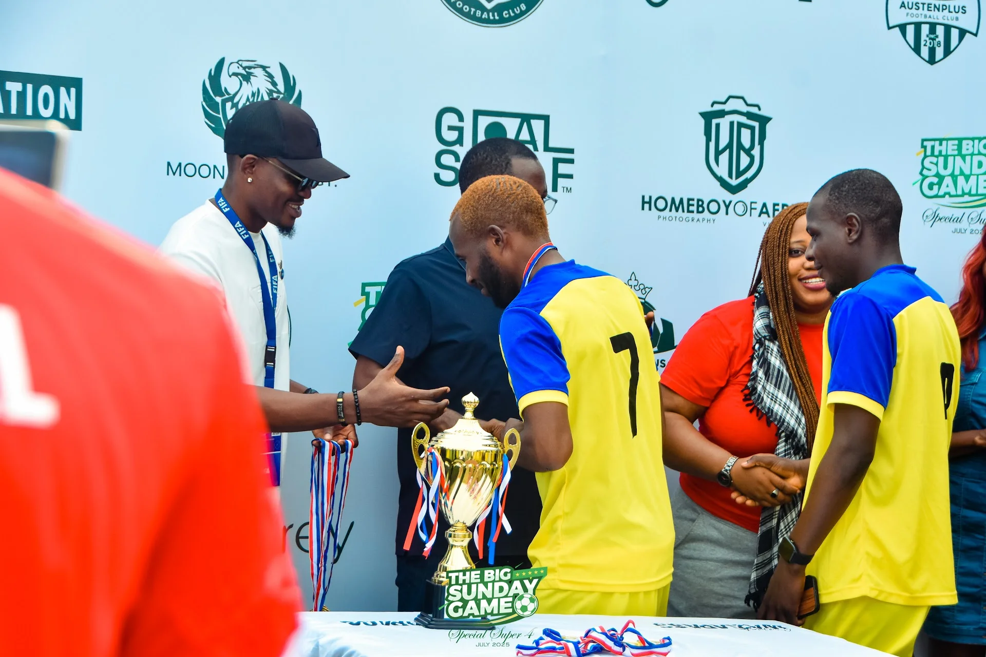 Shegx holding a trophy after a match